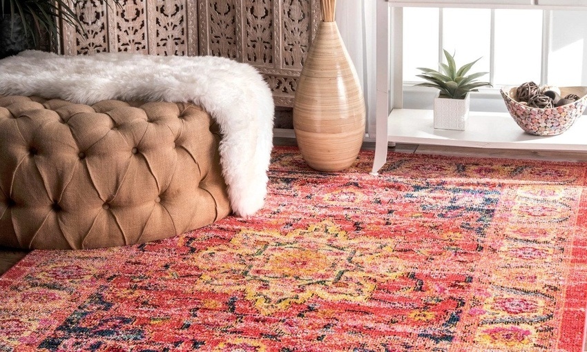 Living room with a Persian rug, white fur blanket, and upscale furniture