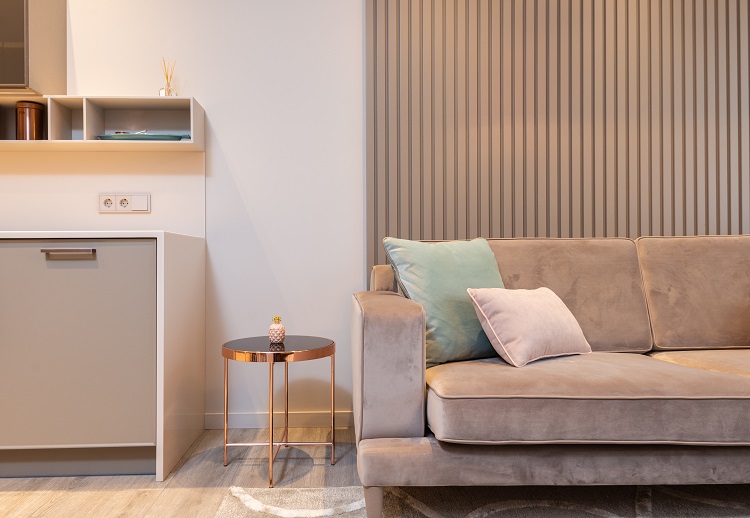 Brown upholstered sofa in living room beside wooden desk