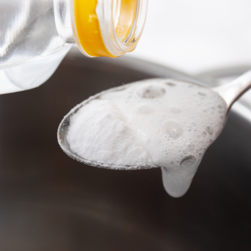 vinegar and baking soda on spoon