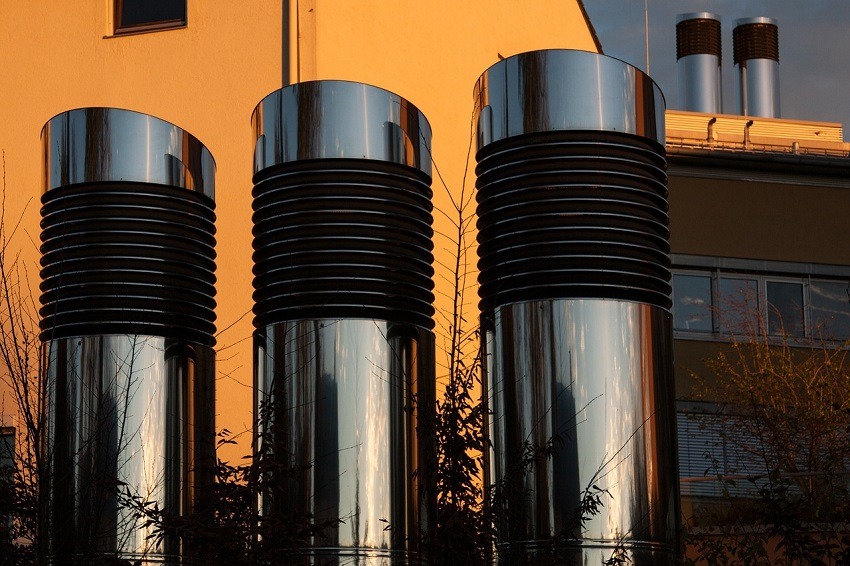 Three adjacent, exposed rooftop vents for industrial air duct system