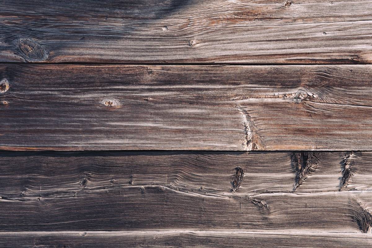 Close-up view of slightly warped hardwood flooring planks