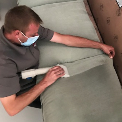 Professional upholstery technician at work
