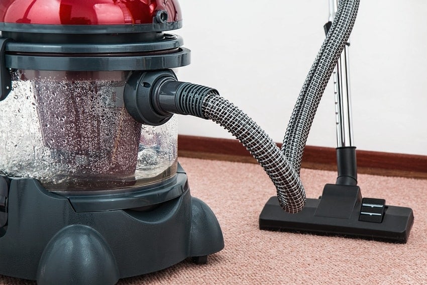 Red rental vacuum for DIY carpet cleaning in Westminster, CO home