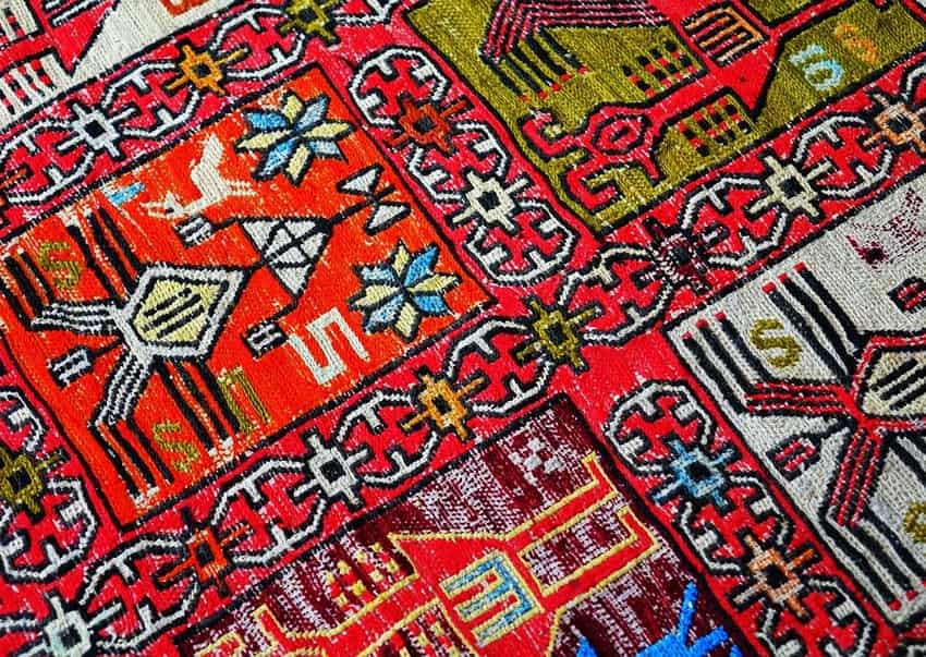 Close-up view of red patterned Persian rug after professional rug cleaning services