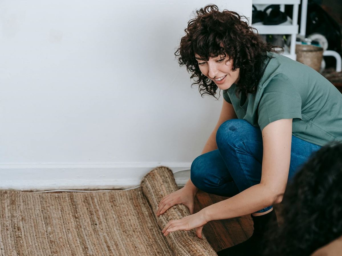 old carpet being rolled up by home owner